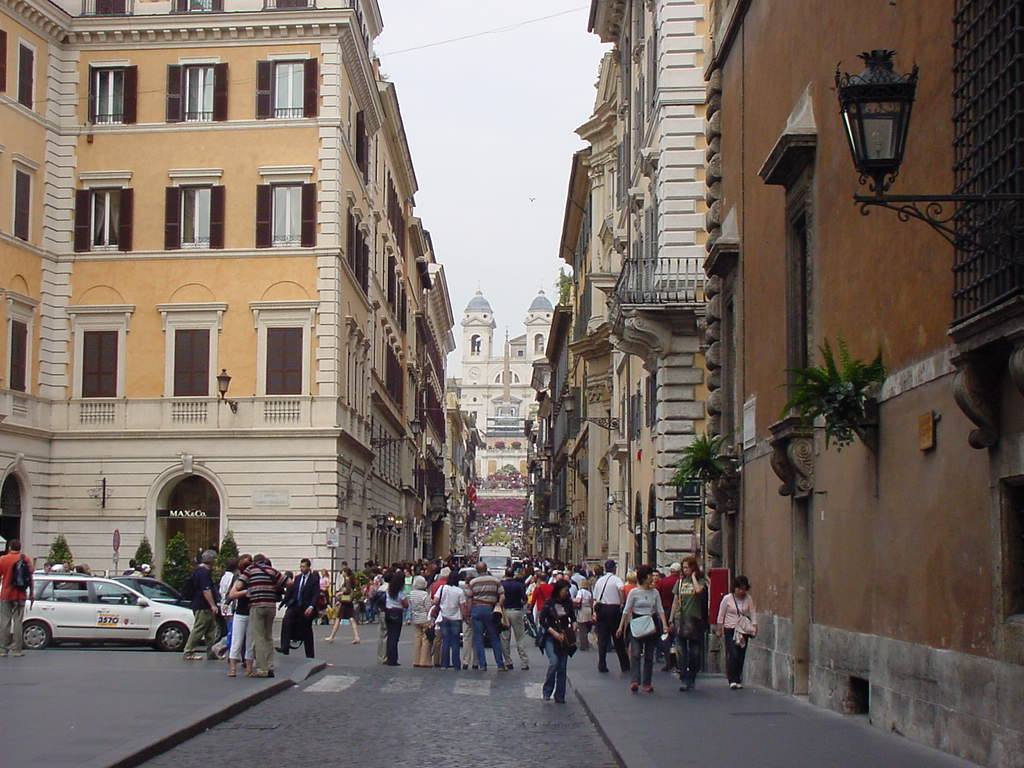 Turisti camminano su Via dei Condotti verso Trinità dei Monti, Roma