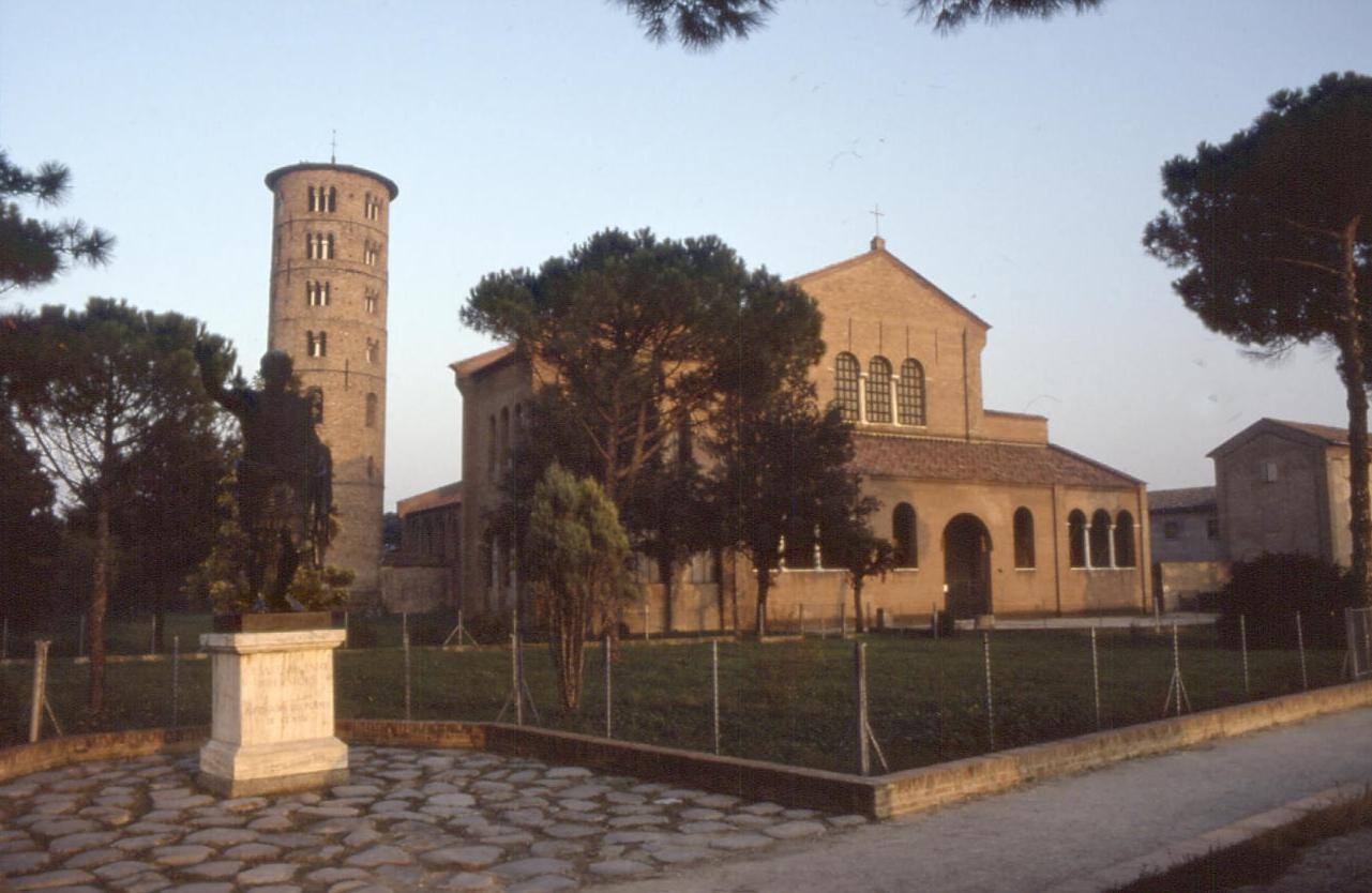 Basilica a mattoni e campanile cilindrico a Ravenna, statua in bronzo su piedistallo