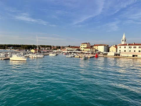 Il porto di Fažana al tramonto, acqua turchese e attesa della barca.