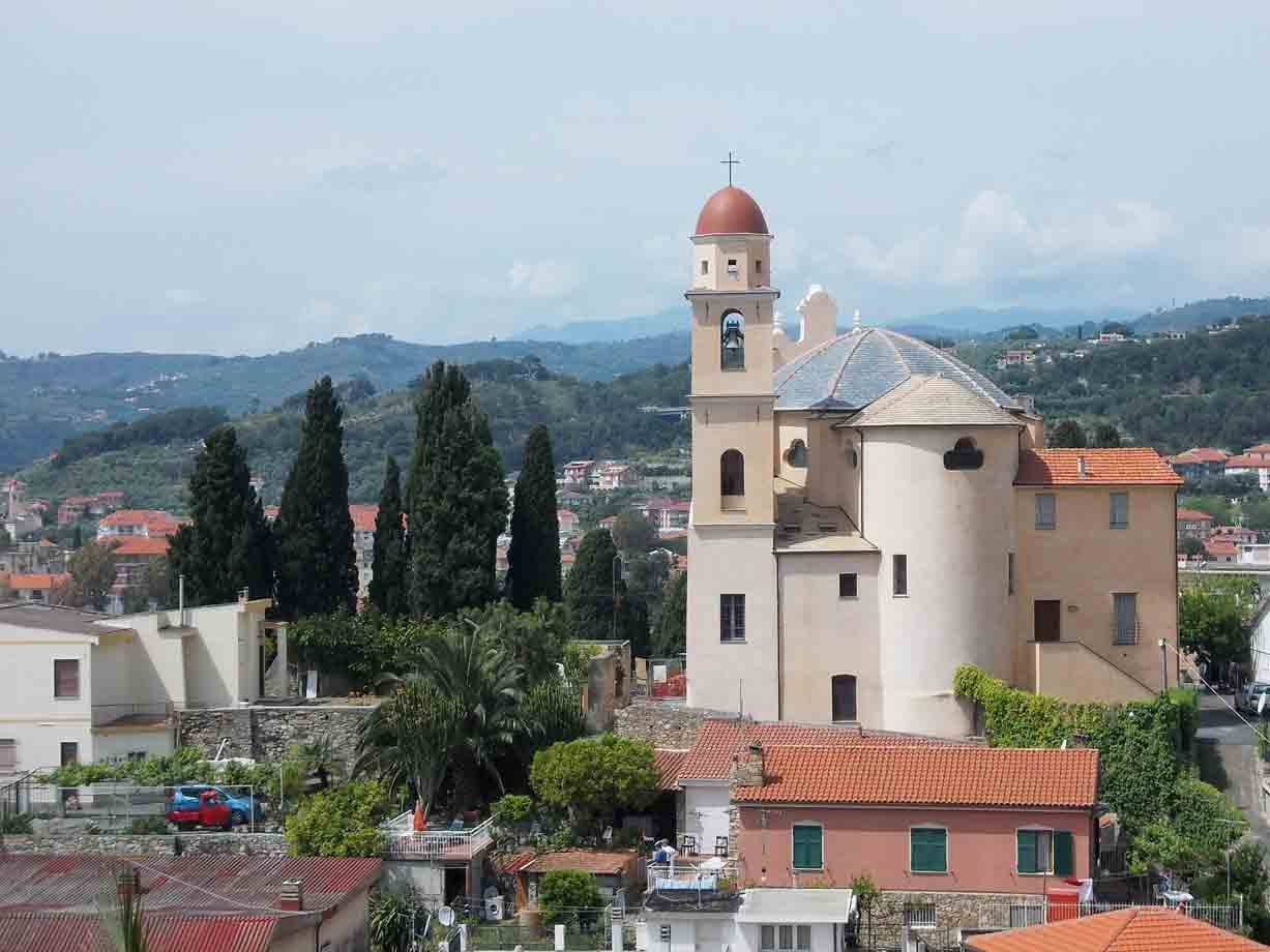 Chiesa con cupola rossa e campanile tra le colline, tetti in coppi